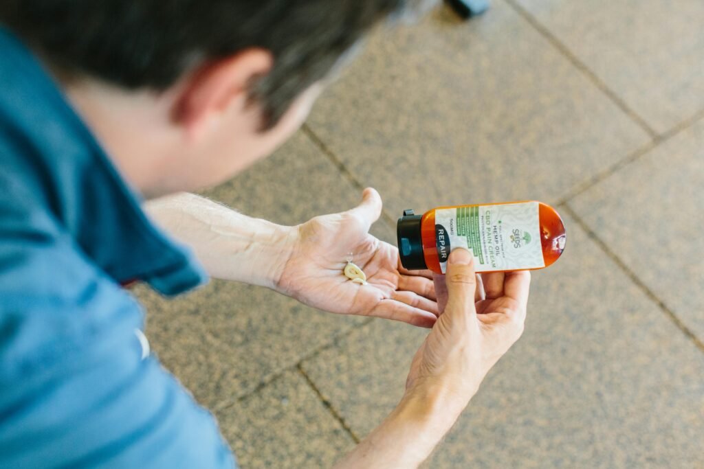 a person holding a bottle of medicine